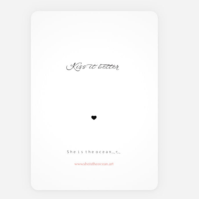 A minimalist Desire greeting art print card with rounded corners, featuring the black cursive text 'Kiss it better' and a small black heart on a white background, with additional text 'She is the ocean.