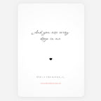 A minimalist white art print greeting card with black cursive quote reading 'And you are every drop in me' above a small black heart, with additional small text and a pink website line near the bottom.