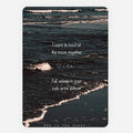 A rectangular art print greeting card or poster featuring a dark ocean shoreline scene with white surf and overlaid white quote reading, 'I want to houl at houl at the moon together', 'Fall asleep in your safe arms forever', and 'She is the ocean'.