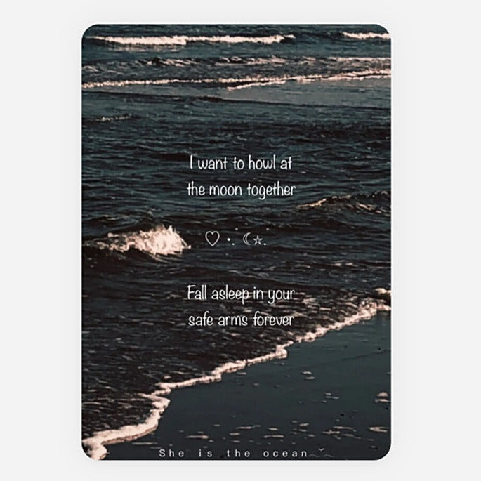 A rectangular art print greeting card or poster featuring a dark ocean shoreline scene with white surf and overlaid white quote reading, 'I want to houl at houl at the moon together', 'Fall asleep in your safe arms forever', and 'She is the ocean'.