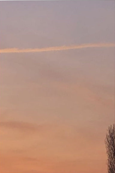 A vertical canvas wall art print depicting a soft pastel sunset sky with lavender, peach, and orange tones, shown against a clean white background.