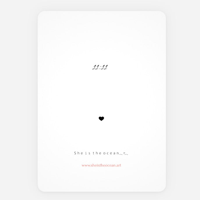 A minimalist Love's Shadow greeting Card white art print with black quote reading '11.11' near the top, a small black heart in the center, and 'She is the ocean.