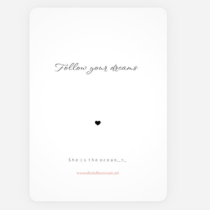 A minimalist white art print greeting card with rounded corners, featuring the cursive quote 'Follow your dreams' in black, a small black heart in the center, and additional small text at the bottom including 'She is the ocean.
